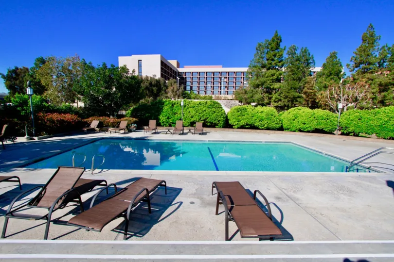 Brookview Costa Mesa California home near big swmming pool blue water cover green grass