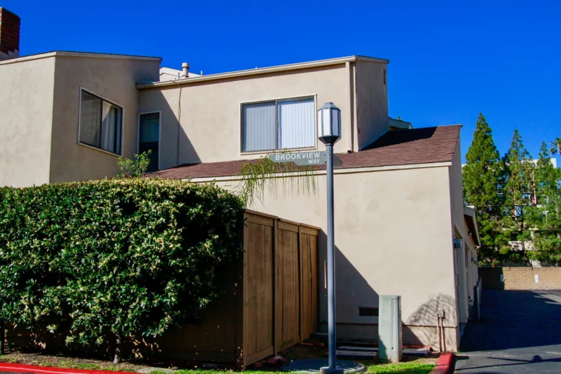 Beige house, with high privacy fence, hedges, street lamp, Brookview, Costa Mesa, California