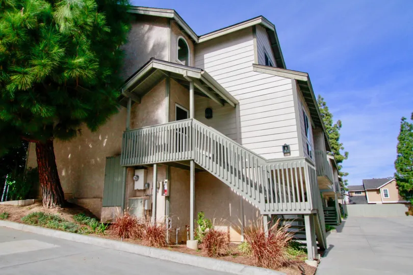 Canyon Walk apartments with a staircase and breaker box on a sunny day.