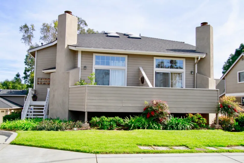 Rear decks and manicured lawns of Canyon Walk homes in Costa Mesa California