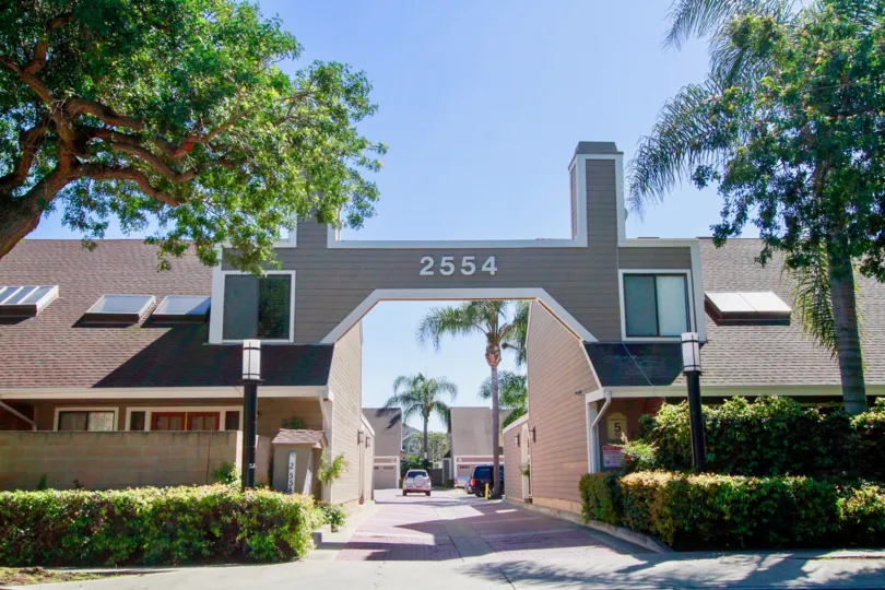 Cedar Glen Townhomes street with bushes and street lamps on either side.