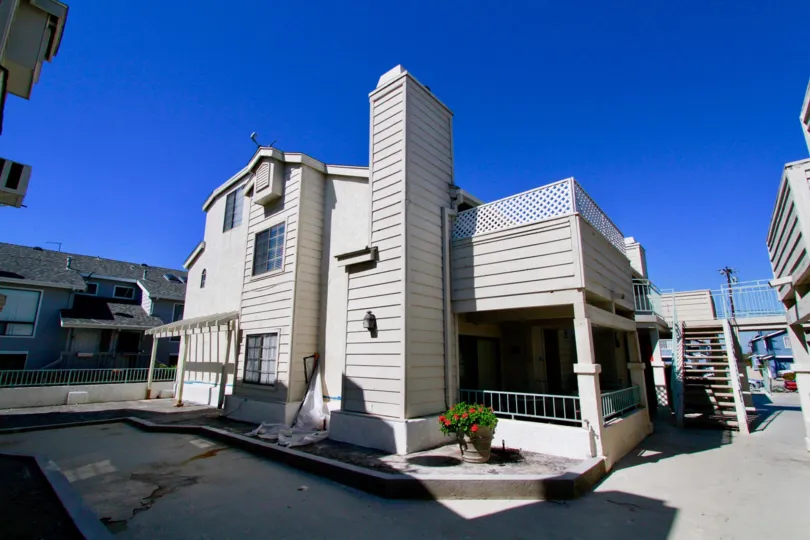 Coral Point apartments with patios, staircase, and balcony on a sunny day.