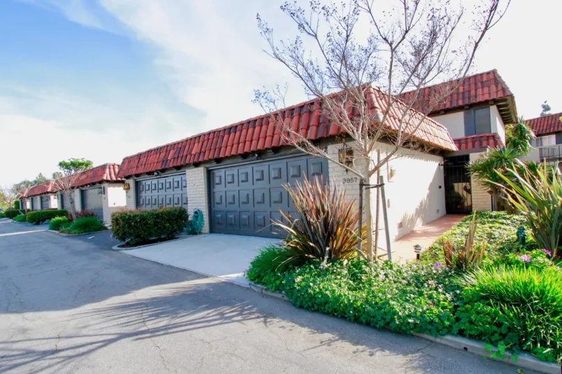 Multiple units of garages with pretty lanscaping in the Country Club Villas community.