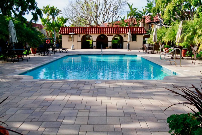 Head on view of the pool at the country club villas, with stone work and seating