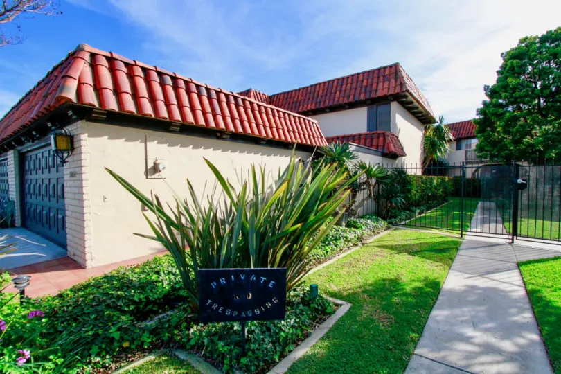 Side view, Spanish style apartments, featuring tile roofs, formal landscaping, Country Club Villas Costa Mesa, California