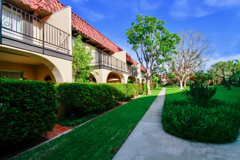 THE APARTMENTS WITH BEAUTIFUL GARDENS AND A SMALL PATH FOR THE HOUSE AND SOME TREES ALSO AVAILABLE AT THE NEAR TO THE TREES AT THE MORNING TIME