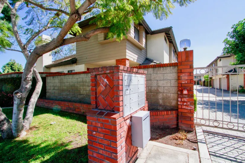 The community of Elden Shadows in the city of Costa Mesa, California. Mailboxes are shown near the gated entrance.