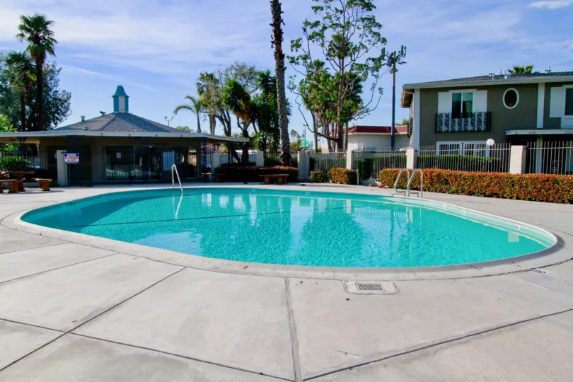 Large community pool and outdoor space on a sunny day in the French Quarters community in Costa Mesa, CA