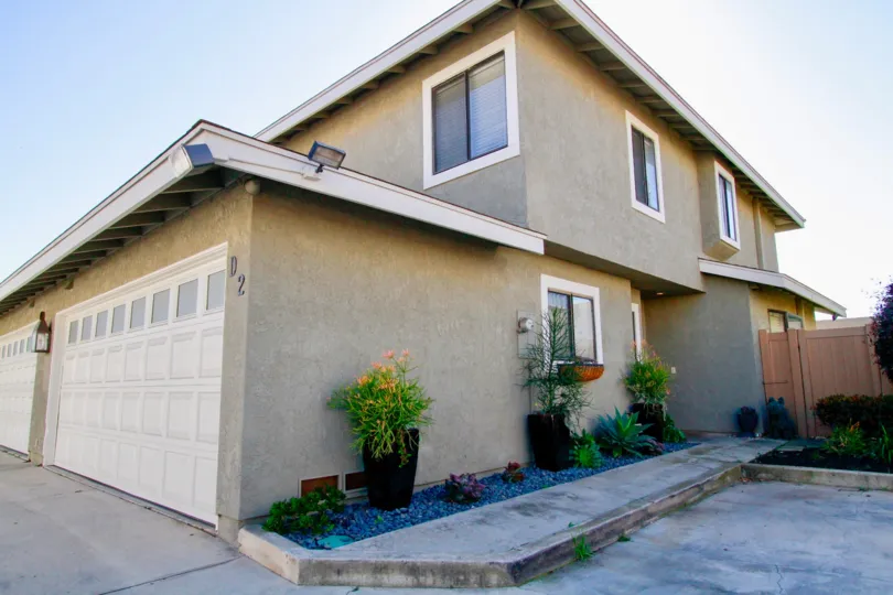 View of two car garage and side entrance to a Hamilton Villas home in Costa Mesa California