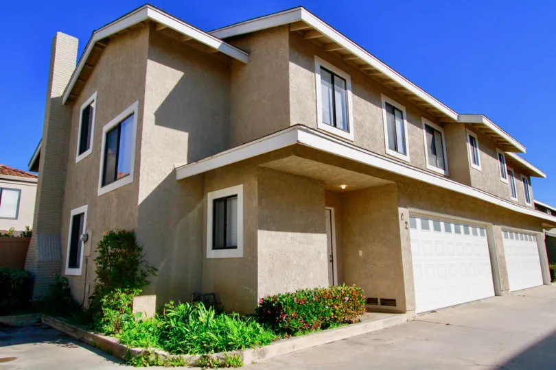 A white bordered light brown building in the community of Hamilton Villas