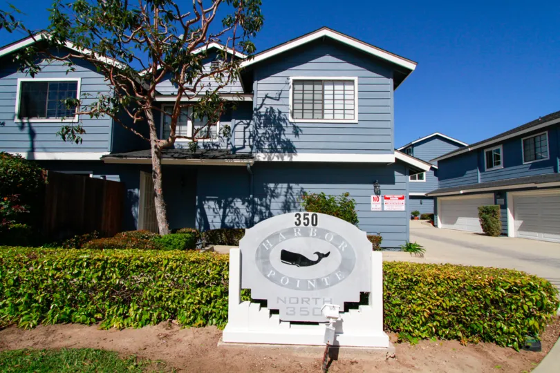 Sunny day blue sky in front of Harbor Pointe North community in Costa Mesa, CA