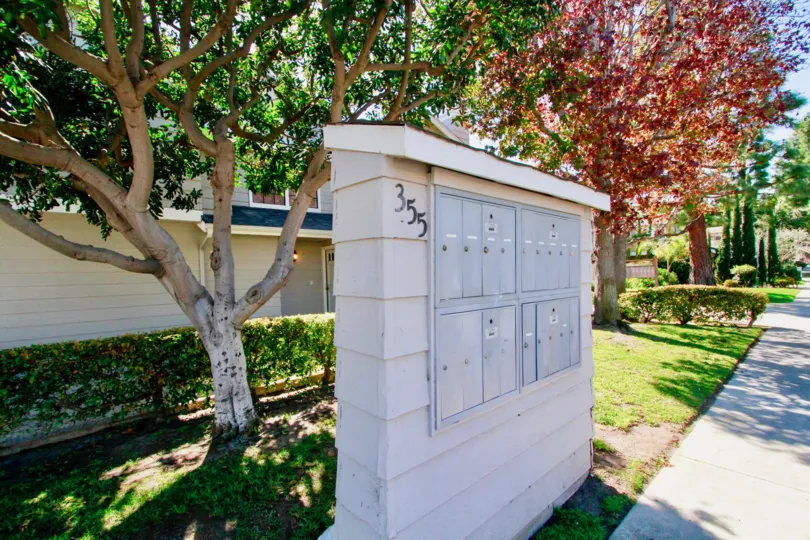 Mailboxes shown in front of the colorful trees of Harbor Pointe South Community residing in Costa Mesa, California