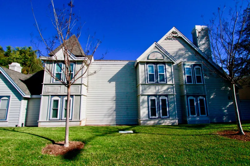 Knowleton Manor apartments with trees and a lawn on a sunny day.