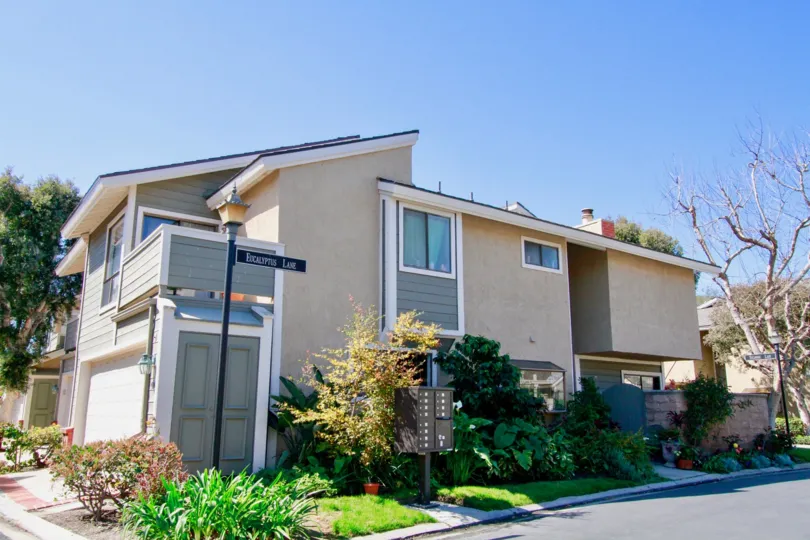 A modern designed home with a large gray door entrace at Laurel Point in Costa Mesa CA