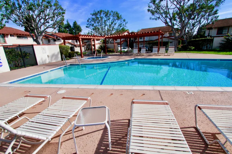 THE POOL WITH RESTAURANT REST ROOMS AND SLEEPING RELAXATION CHAIRS ALSO AVAILABLE AND SOME TREES NEAR TO THE POOL AT THE MORNING TIME