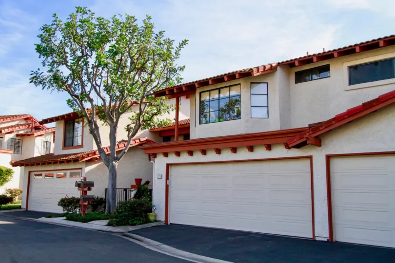 Residential homes with garages in the Longwood Greens community.