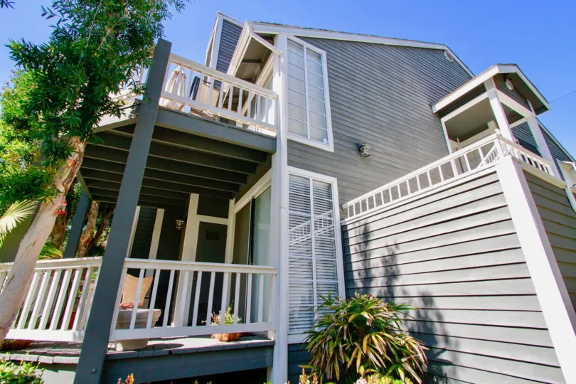The huge house in the Newport Landing is like a cottage house with lots of trees and plants.
