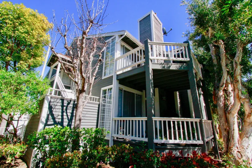 Newport Landing home with trees and balconies on a sunny day.