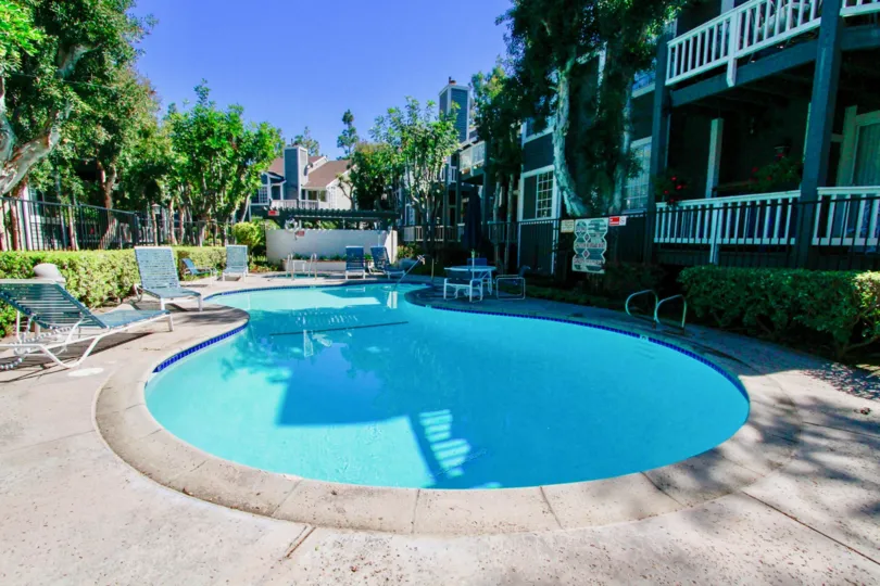 Newport Landing pool with deck chairs and tables on a sunny day.