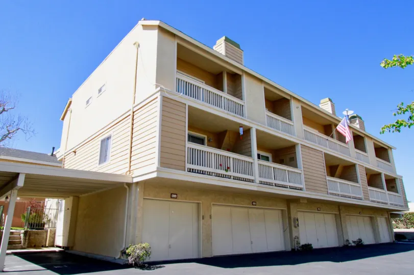 Side view of Ocean Breeze Villas garage doors and terrace in Costa Mesa, CA