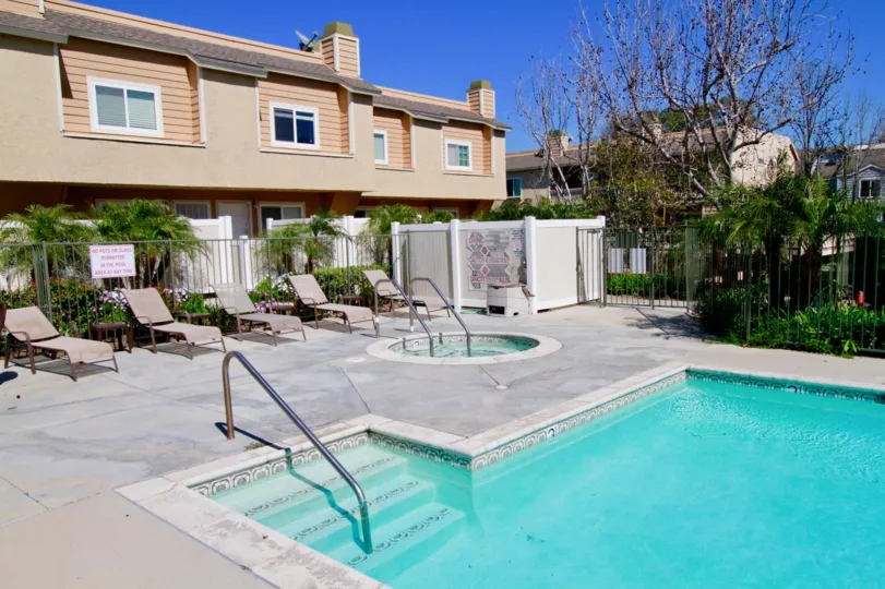 The house in the Ocean Breeze Villas is like a restaurant and also with swimmingpool with chairs and plants, trees.