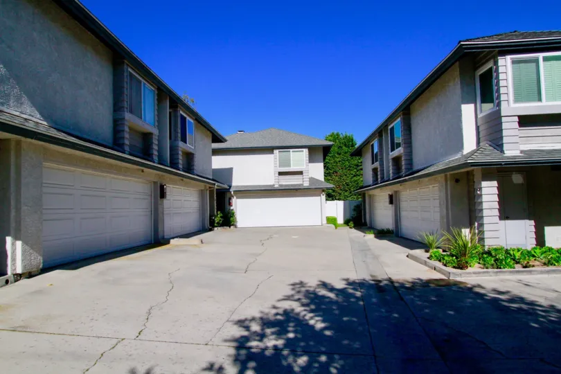 Pelican Point street with two story apartments on either side on a sunny day,