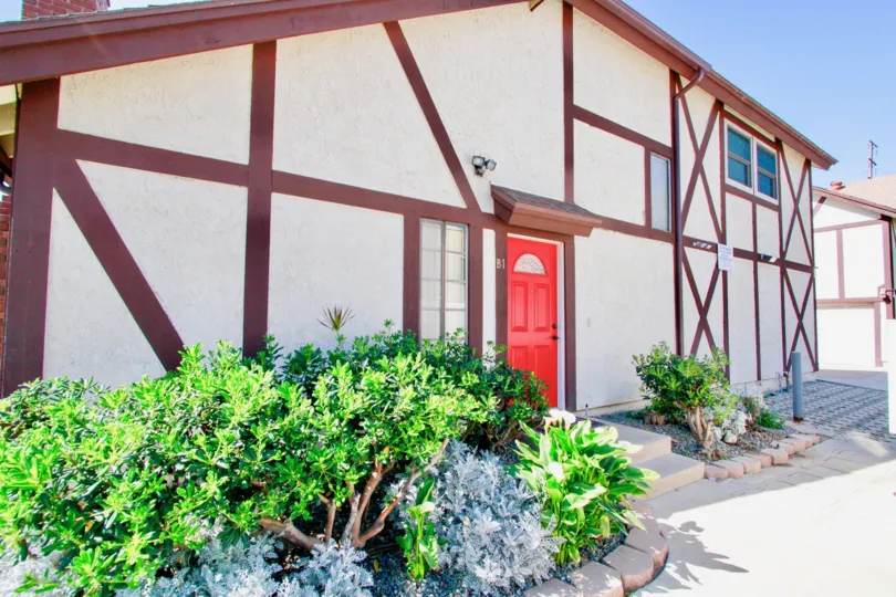 Picadilly Terrace Costa Mesa California cross lined wall design looks different with red door