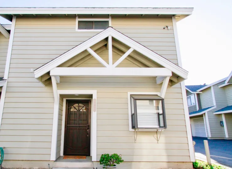 White trim, tan apartment with oak door and bay window