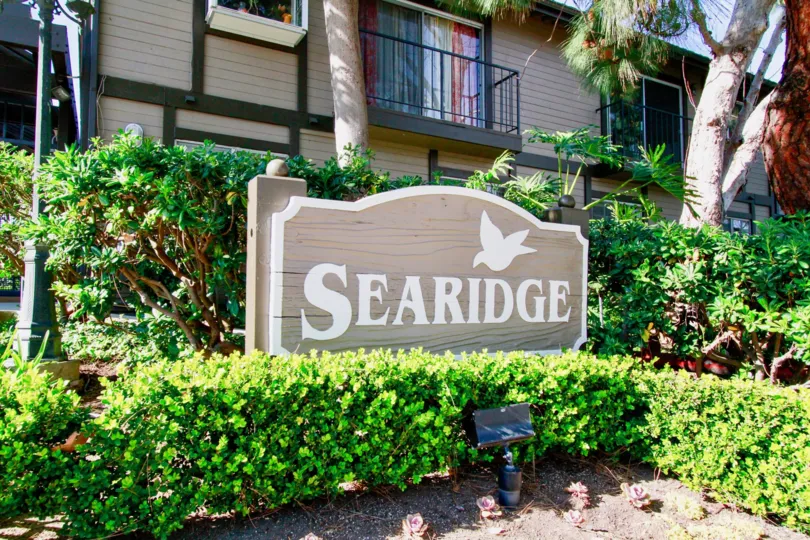 The building in the sea ridge is like a hometown house with garden full of trees, plants and also with nameboard.