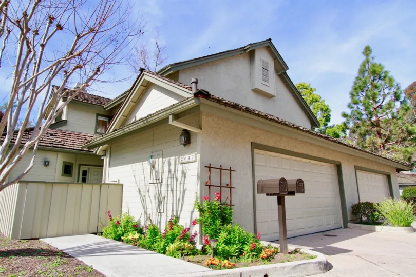 THE MEDIUM SIZE HOUSE LOCATED ALONE AND SOME PLANTS WITH PINK COLOUR FLOWERS ALSO AVAILABLE AND SOME TREES ALSO NEAR TO THE HOUSE.