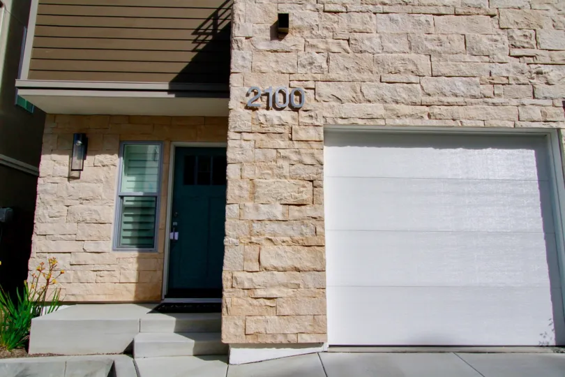 Seabreeze apartments with a white garage and a green door.