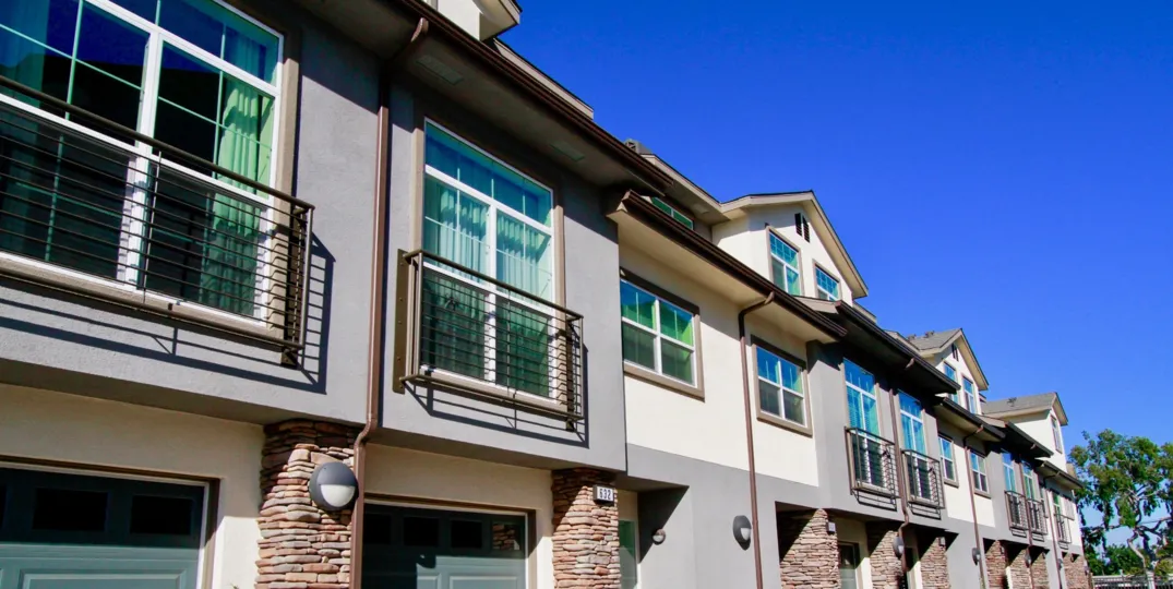 Seabright Costa Mesa California bulding all room attached glass window light gray color paint building right side big tree