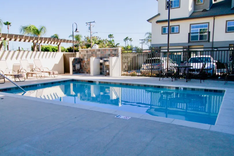 A sunny day in the Seabright with swimming pool and chair and also with car parking.