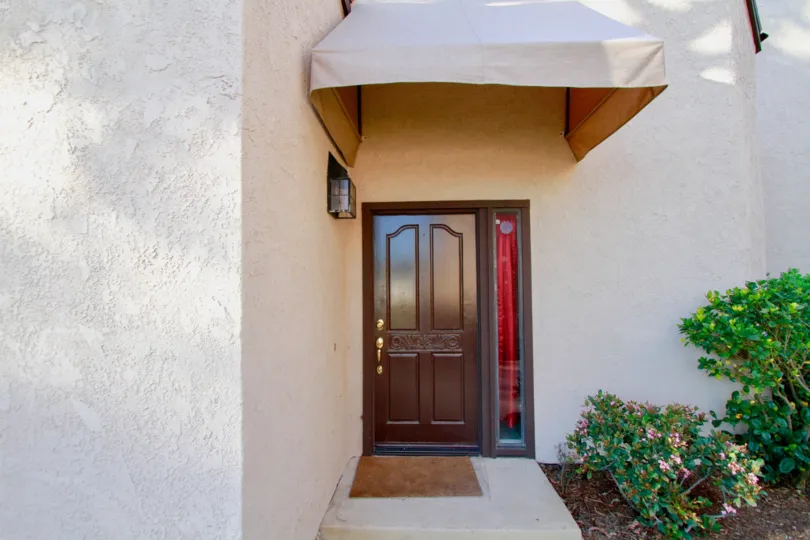 Polished, wooden door, with canopy, hedges, Sommerset, Costa Mesa, California