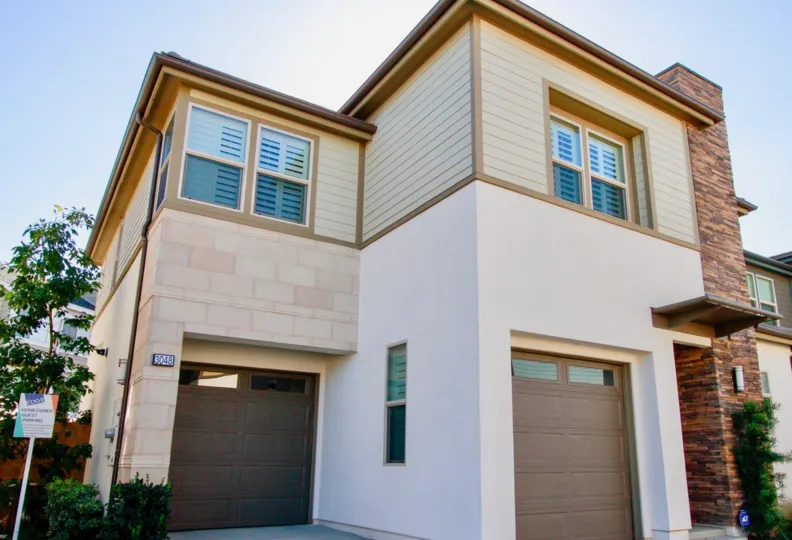 THE BUILDING WITH TWO FLOORS AND A FRONT GATE ASLO AVAILABLE AT THE GROUND FLOOR THEN SOME TREES ALSO NEAR TO THE HOUSE AT THE MORNING TIME.