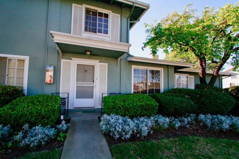 A two story townhome with faux shutters at The Vendome in Costa Mesa