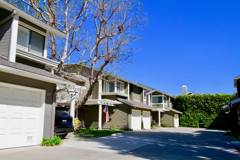 Beautiful spacious villas with sunshine and trees with USA Flag in The Village at Admiral Way of Costa Mesa