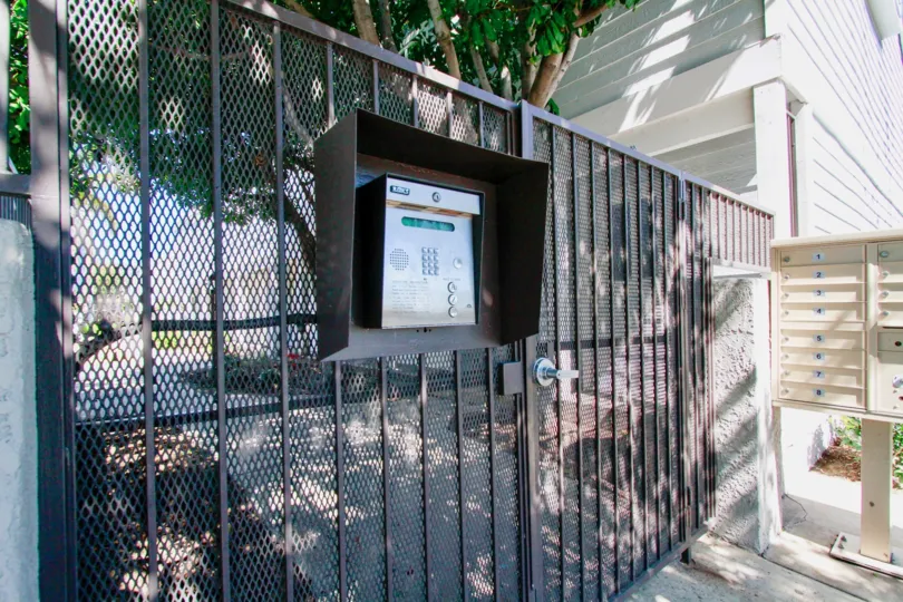 Victoria Garden Villas gate with mailboxes and trees.
