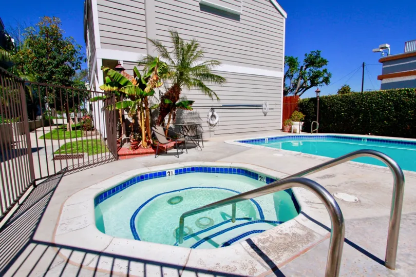 Awesome looking swimming pools with palm trees near villas in Victoria Garden Villas of Costa Mesa