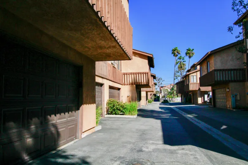 Villa Maple street with trees and apartment buildings on either side.