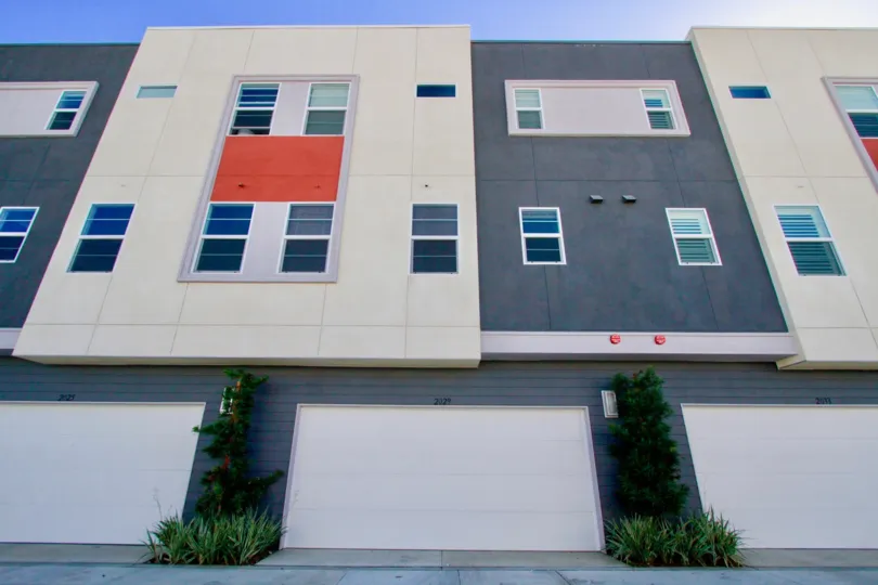 A large three story structure with a red cloth covered window at West Place in Costa Mesa CA