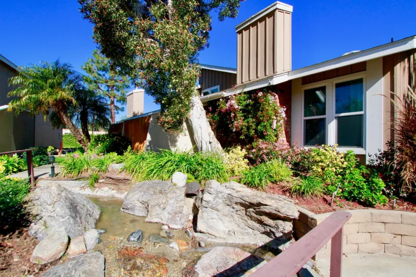 A small pond and trees on a sunny day outside of Woodstream Condos in Costa Mesa, Ca.