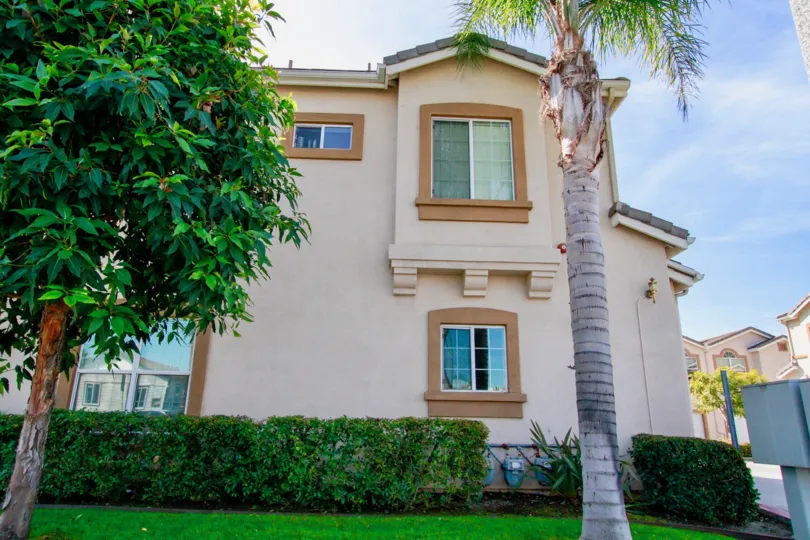 A HOUSE WITH TWO FLOORS ANN WINDOWS ALSO AVAILABLE AND THE DOOR ALSO CLOSED AND SOME TREES AND PLANTS ALSO AVAILABLE