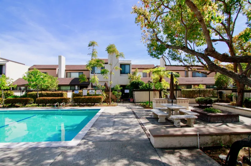 Bowers Condominiums Cypress California blocks with colored trimmed plants and stone benches and grill gates
