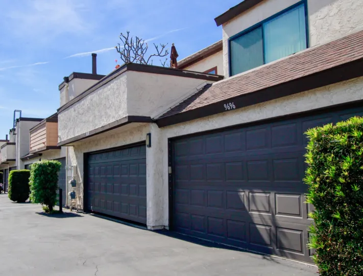 A garage and front view of a unit at Bowers Condominiums on a sunny day