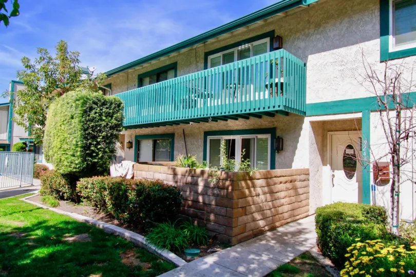 The entrance to a home in Cambria Townhomes on a sunny day showing the landscaping