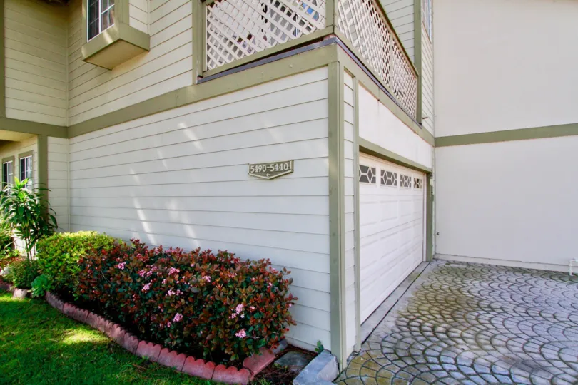 a garage with a beautiful lattice porch on top in a house in Cambridge Commons.