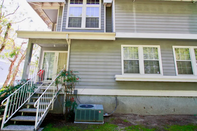 A HOUSE WITH WINDOWS GLASS AND THE STEPS ALSO AVAILABLE FOR MAIN DOOR AND SOME PLANTS ALSO NEAR TO THERE AT THE MORNING