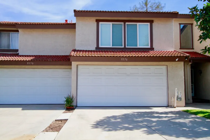 The garages and upper story windows of a building in Cypress VIllas