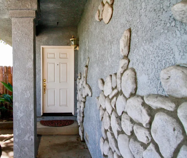 THE DOOR CLOSED AND A WALL ALSO THERE AND SOME DESIGNS ALSO AT THE WALL A PILLOW ALSO AVAILABLE
